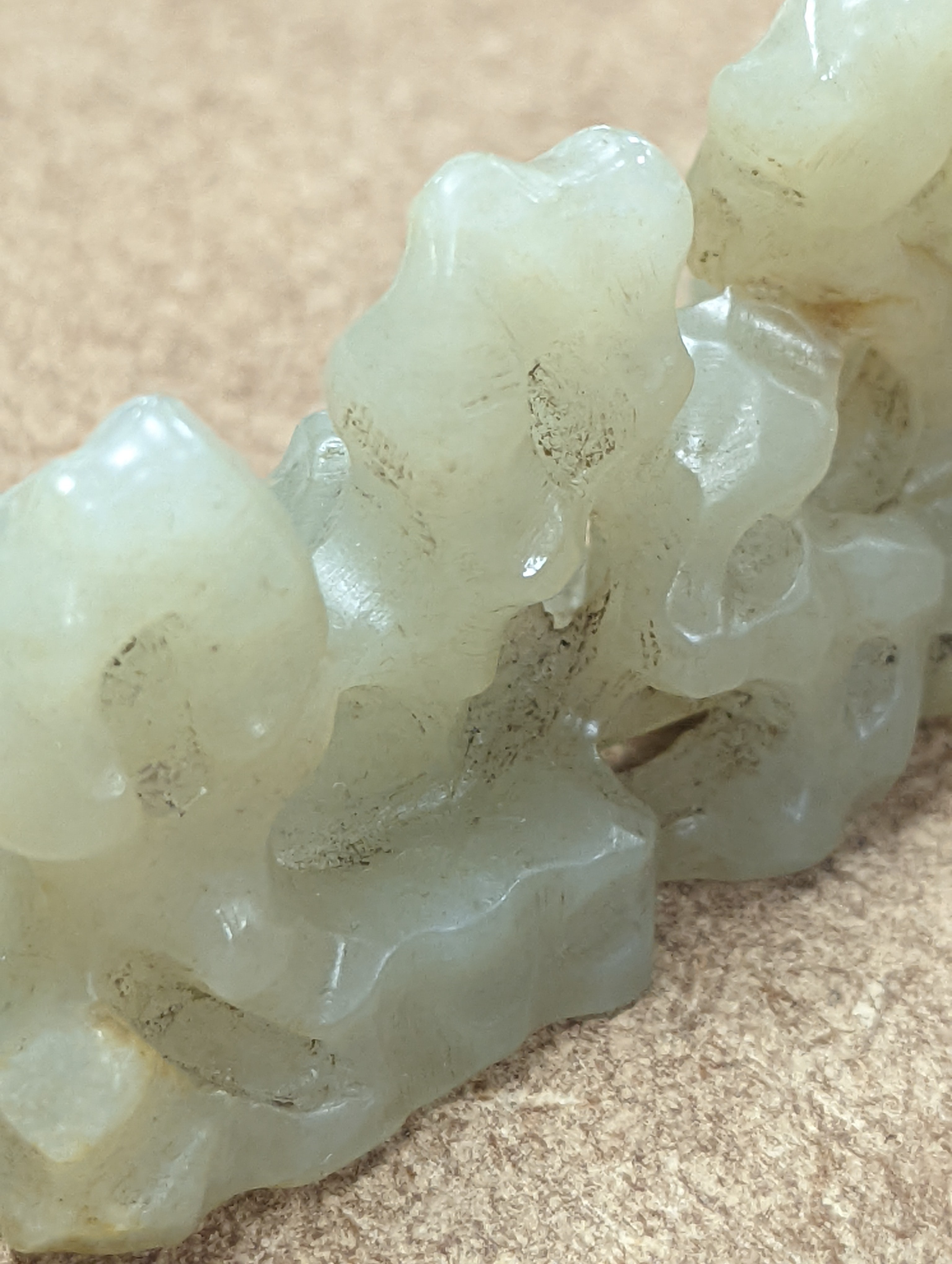 A Chinese celadon jade brush rest, 8cms wide